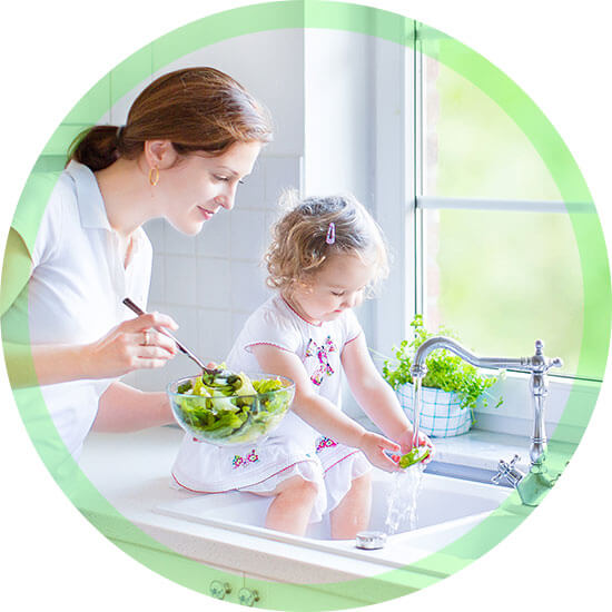 mother and daughter washing their veggie